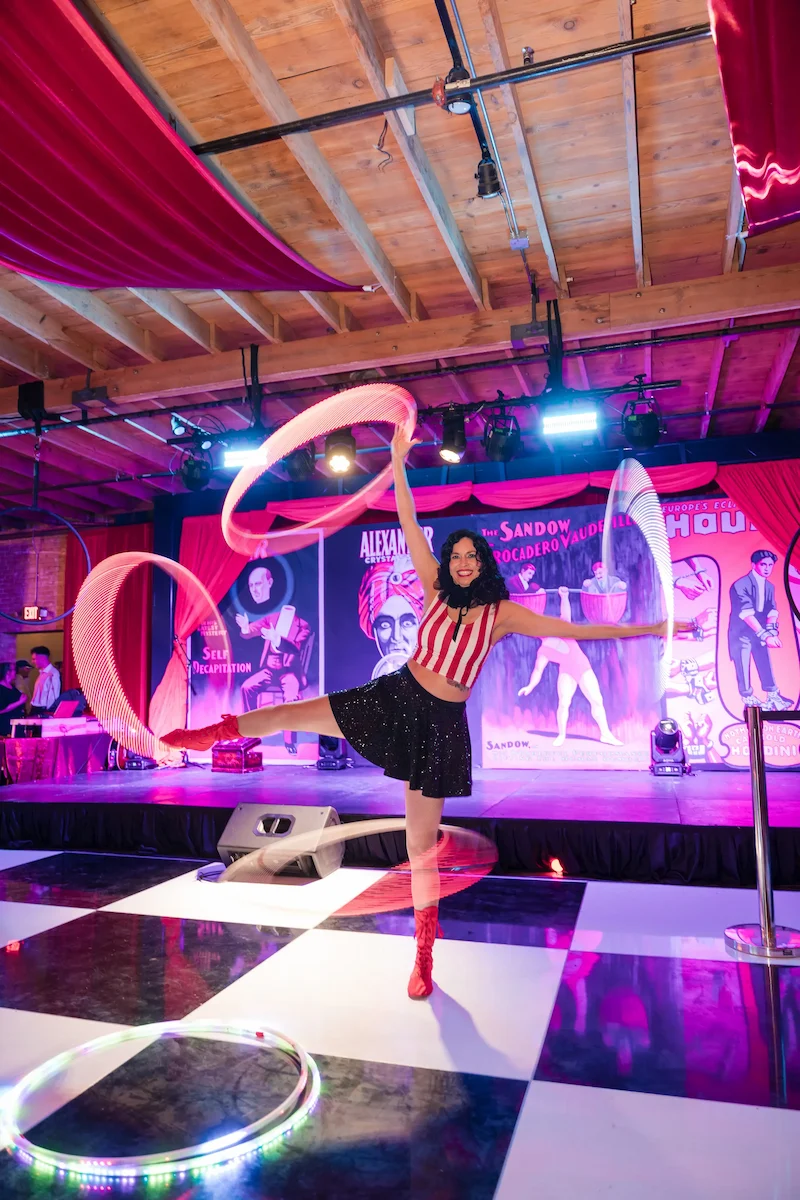 circus artist hula hooping 4 hula hoops at a Corporate event
