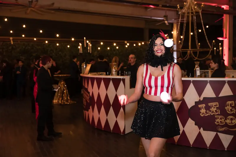 circus performer juggling three balls under the big top