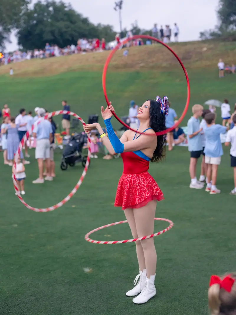 hula hooper spinning three hula hoops at an outdoor festival